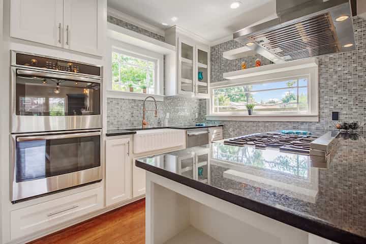 An image of a modern kitchen with sleek appliances, featuring a gas stove, refrigerator, and built-in microwave in New Braunfels